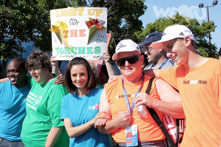 WeLoveU volunteers cheer on participants of the Special Olympics