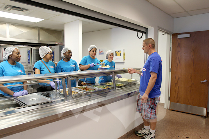 WeLoveU volunteers serve a guest at Bergen County Housing and Human Services Center