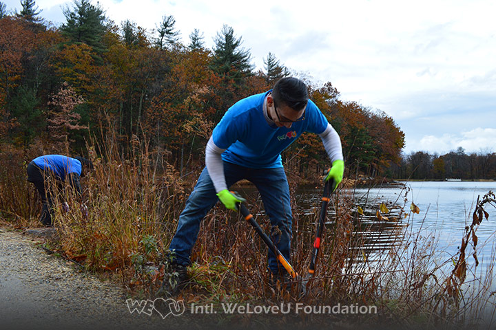 WeLoveU volunteers clean Barrett Park in Massachusetts.