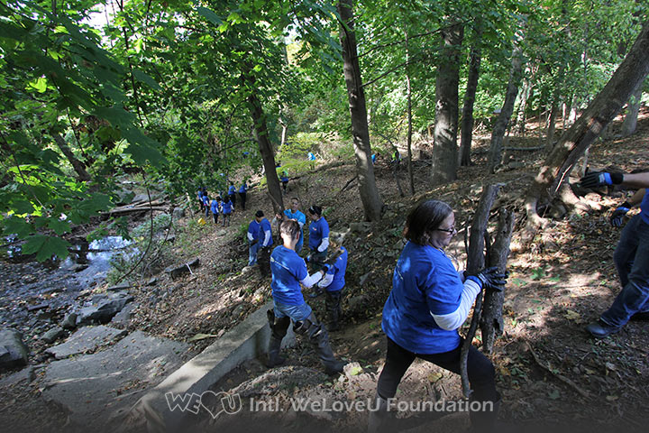WeLoveU volunteers clean Wolf Creek in Ridgefield, NJ.