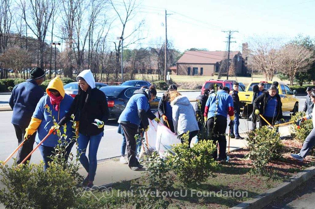 WeLoveU volunteers clean on the side of Albemarle Road
