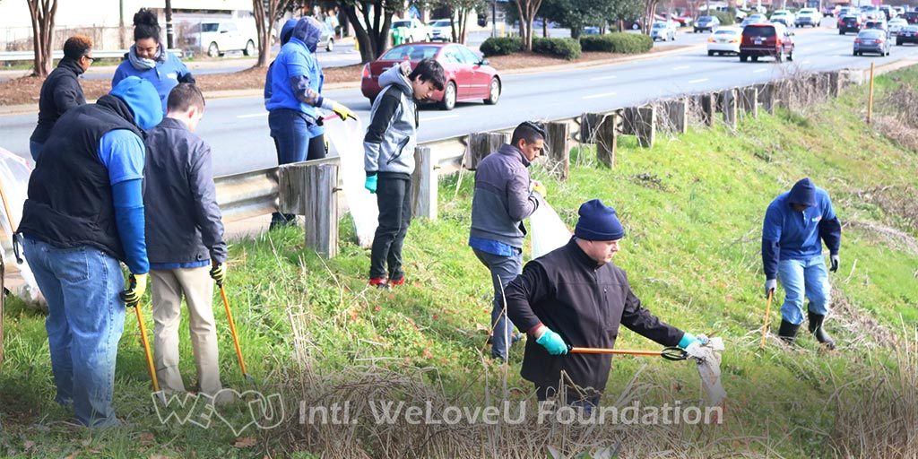 WeLoveU volunteers clean on the side of Albemarle Road