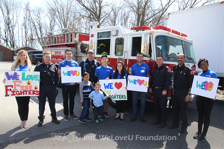 Local firefighters take photo with WeLoveU volunteers