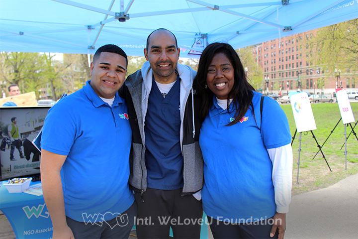 MA State Rep Jon Santiago takes a photo with WeLoveU volunteers