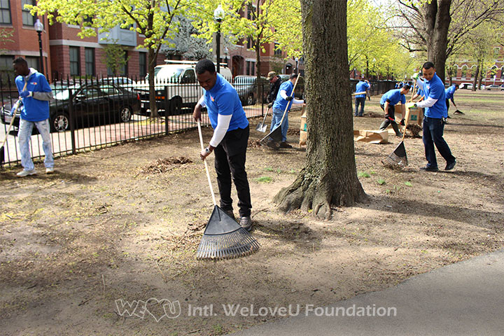 Raking leaves in Boston's Blackstone and Franklin Square on Earth Day