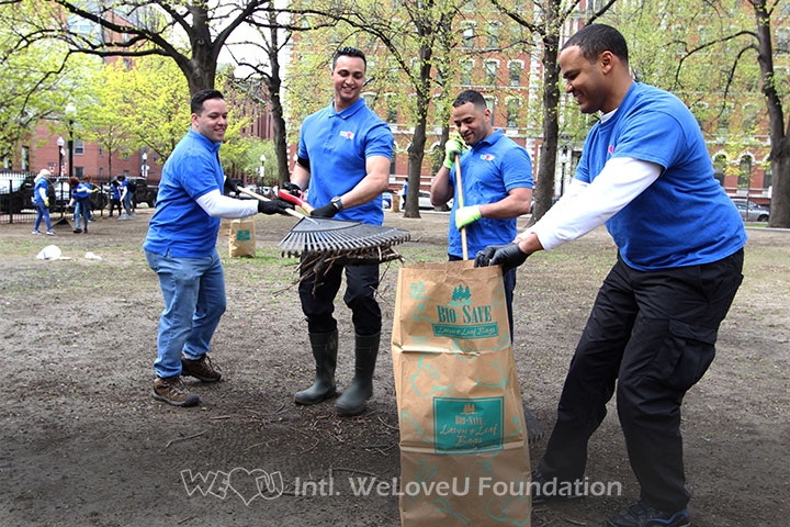 WeLoveU volunteers raking leaves on Earth Day
