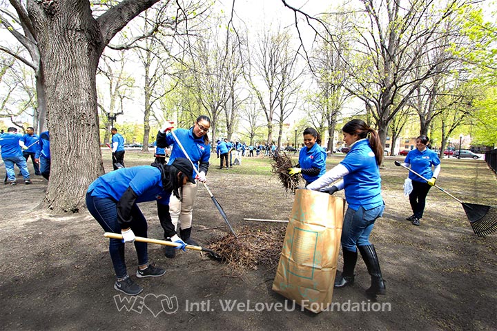 Volunteers work together to rake up the leaves at Blackstone and Franklin Square.