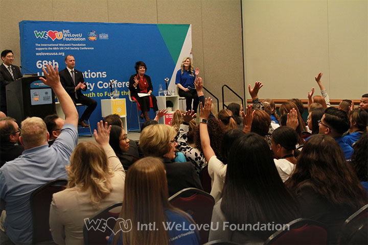 WeLoveU Workshop participants, United Nations Civil Society Conference, raising hands