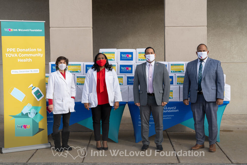 Dr. Nina Anderson and WeLoveU representatives stand with the PPE donations