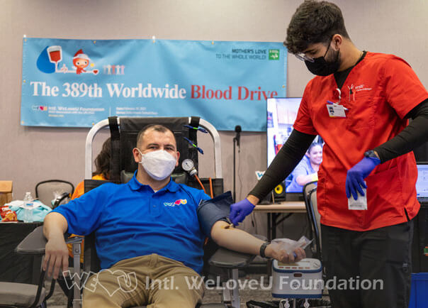 A phlebotomist preps a donor's arm for blood donation