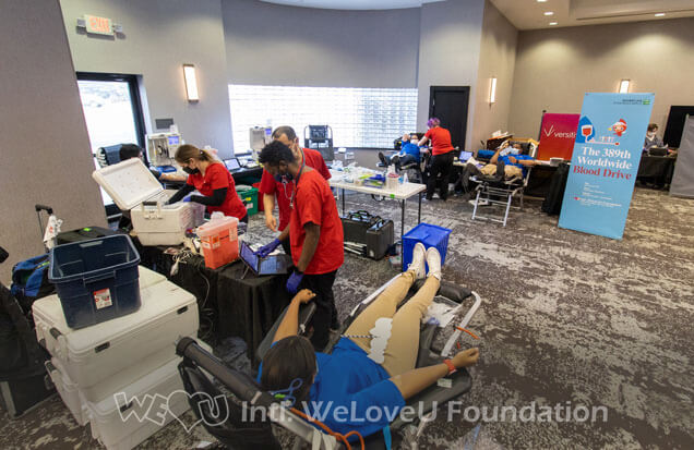 A big room with physically distanced volunteers donating on donation beds