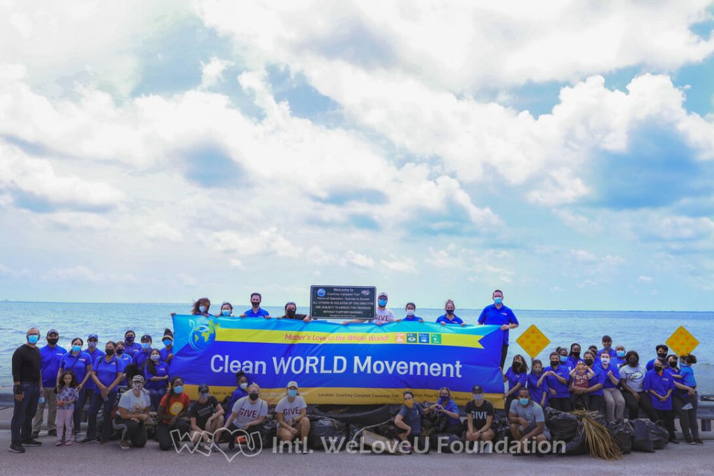 Volunteers sit together in front of the Courtney Campbell Causeway