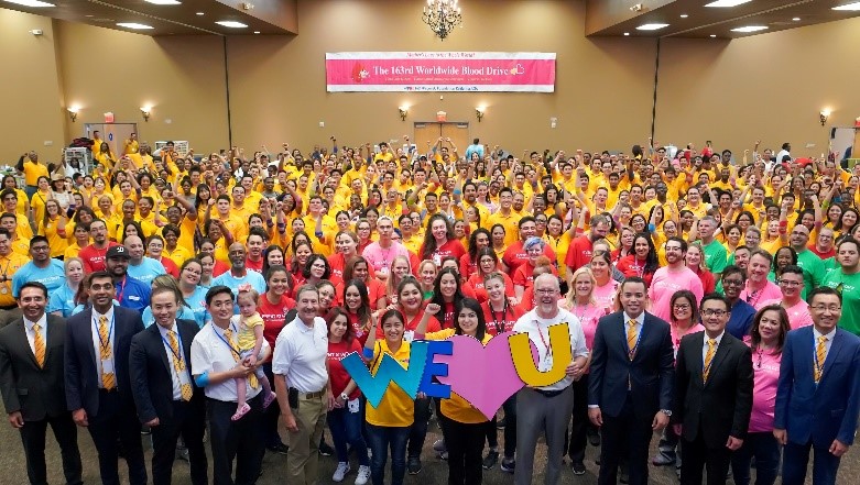 Hundreds of blood donors take a group photo inside the National Orange Show Events Center