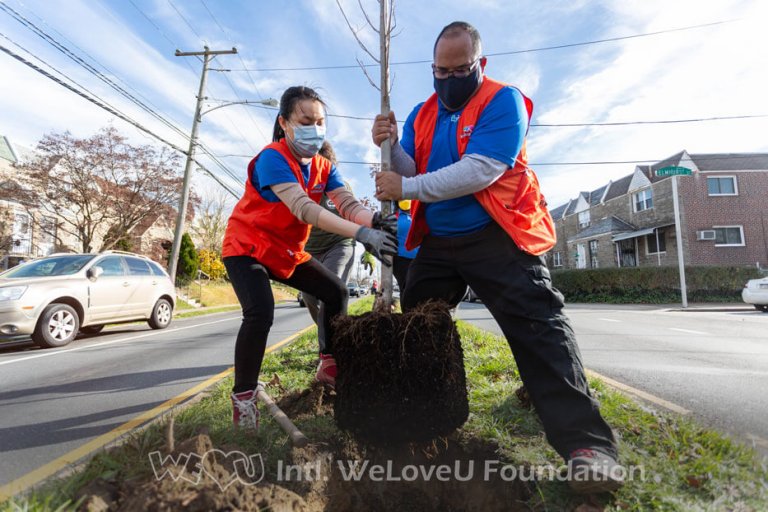 Two WeLoveU volunteers plant a tree in Northeast Philadelphia