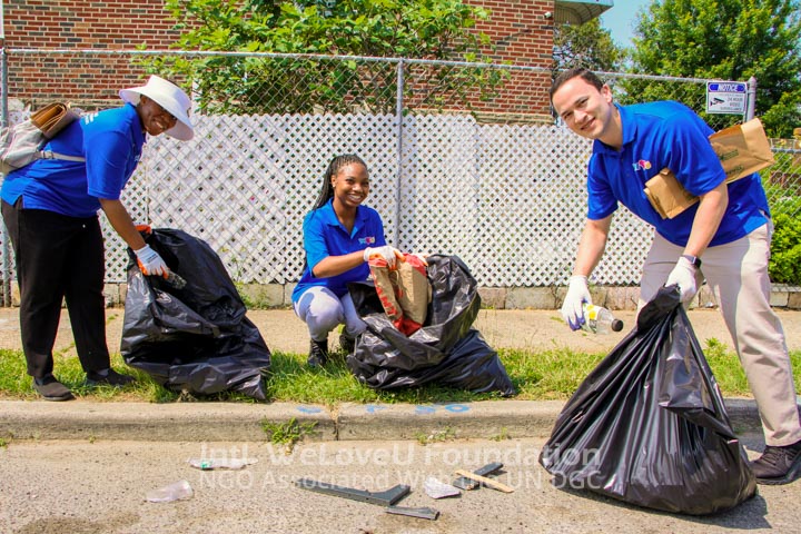 Volunteers placing trash in bags