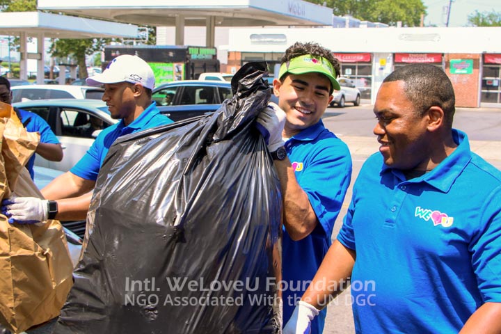 Volunteer holding heavy trash bag