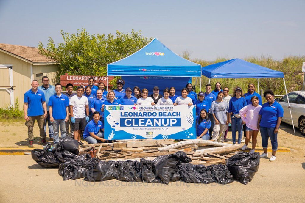 Volunteers take a group photo with the collected trash