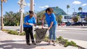 volunteers pick up trash in front of the florida aquarium