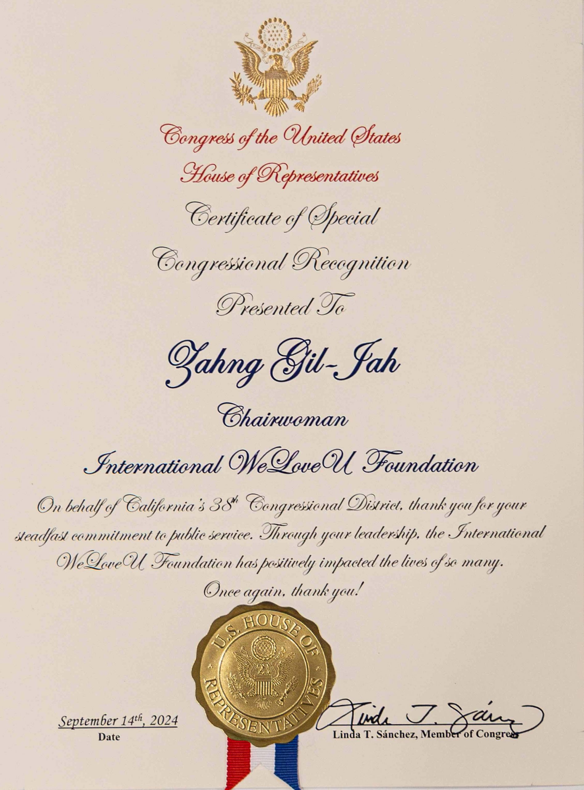 Congresswoman Linda Sanchez honors Zahng Gil-jah with a certificate of special congressional recognition