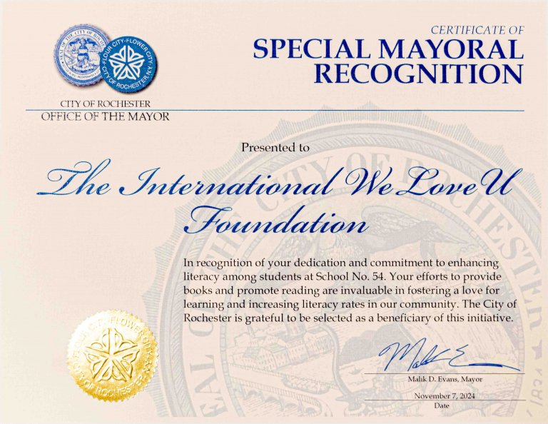 Rochester Mayor Malik Evans signs a certificate of special mayoral recognition to the weloveu foundation